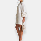 A model in the apricot embossed floral dress enjoying a sunny day, illustrating its breathability and freedom of movement.