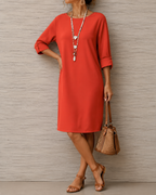 Detailed shot of the clean round neckline and soft material of the Linnea midi dress, perfect for any occasion.