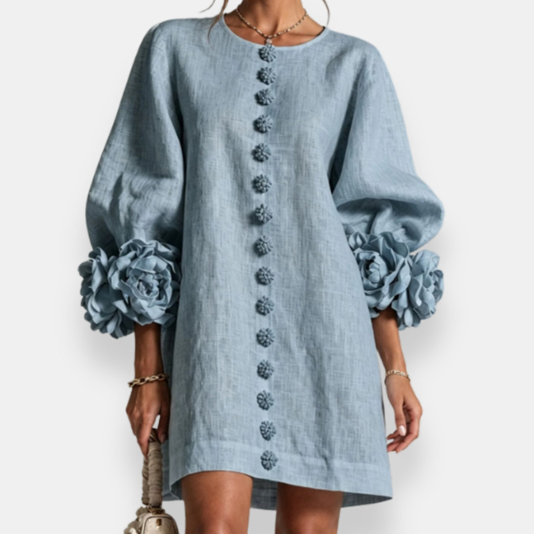 A model gracefully walking in the white embossed floral dress, showing the flow and movement of the design.