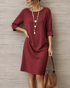 Close-up of the breathable fabric and neatly rolled cuff detail on the three-quarter sleeve of the dress.