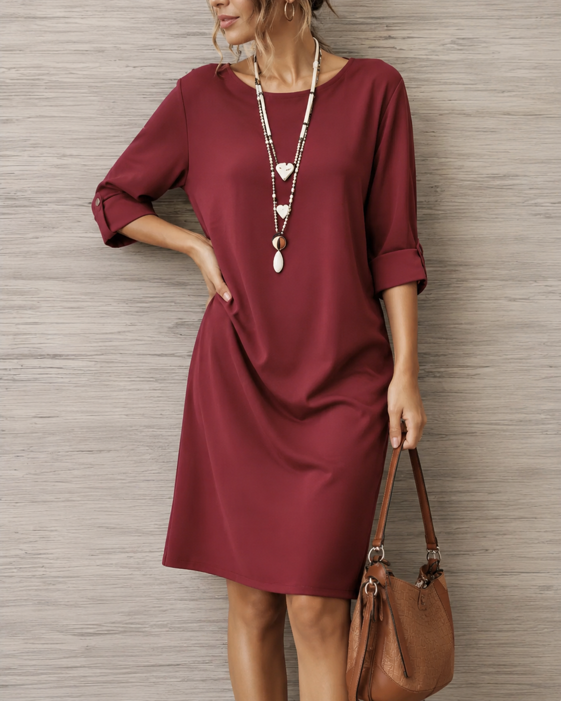Close-up of the breathable fabric and neatly rolled cuff detail on the three-quarter sleeve of the dress.