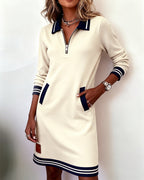 Lifestyle shot of a woman wearing the long sleeve dress, walking outdoors with a casual vibe.