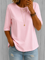 Woman styling the blue relaxed half-sleeve t-shirt with a skirt, demonstrating its versatility.