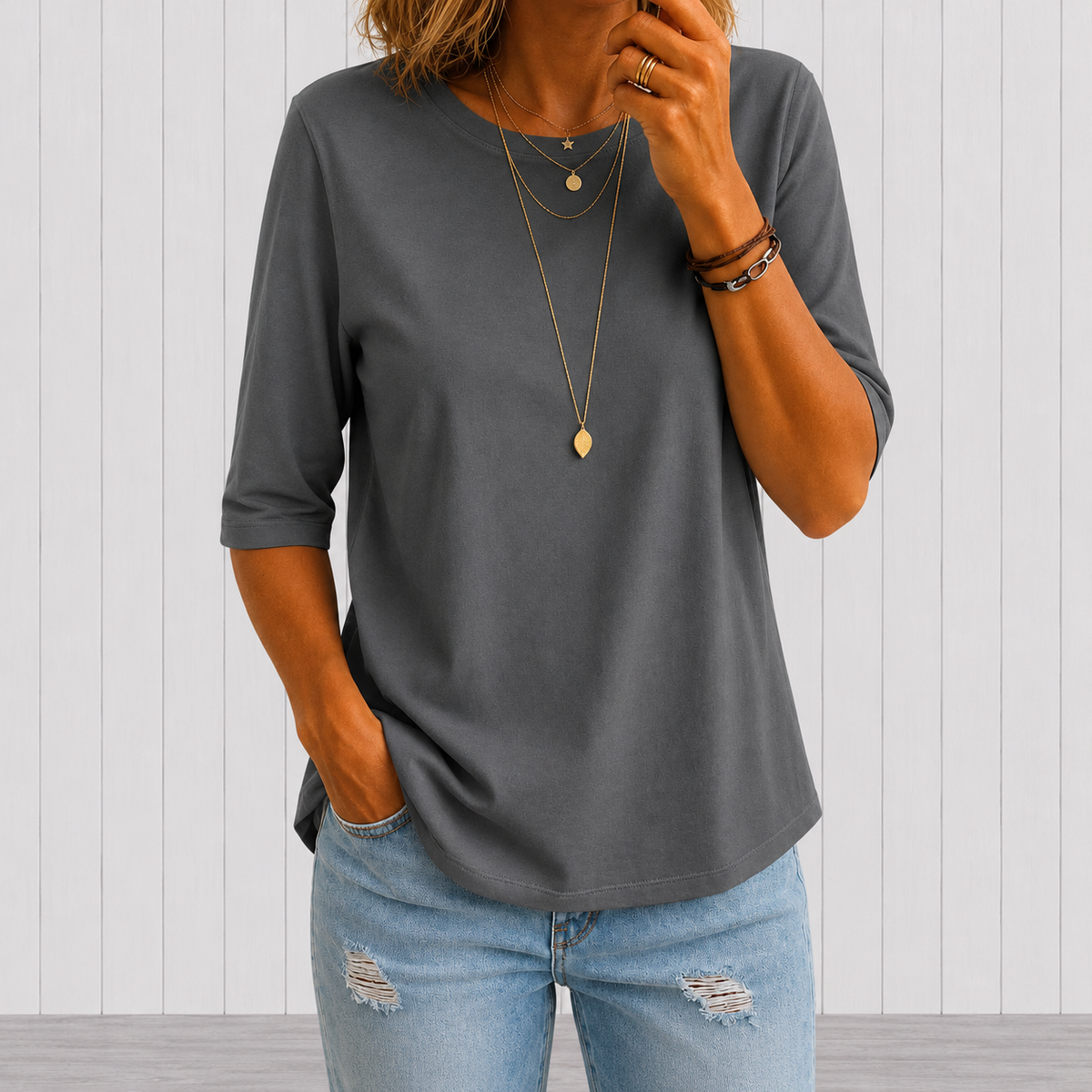 Detail shot of the half-sleeve length on a black t-shirt, providing extra arm coverage.