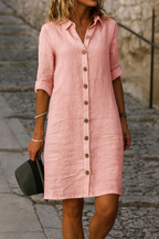 Model smiling and posing in the pink linen summer dress, capturing the garment's comfortable drape.