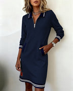 A group of various colors of the long sleeve dress folded neatly, ready for selection.