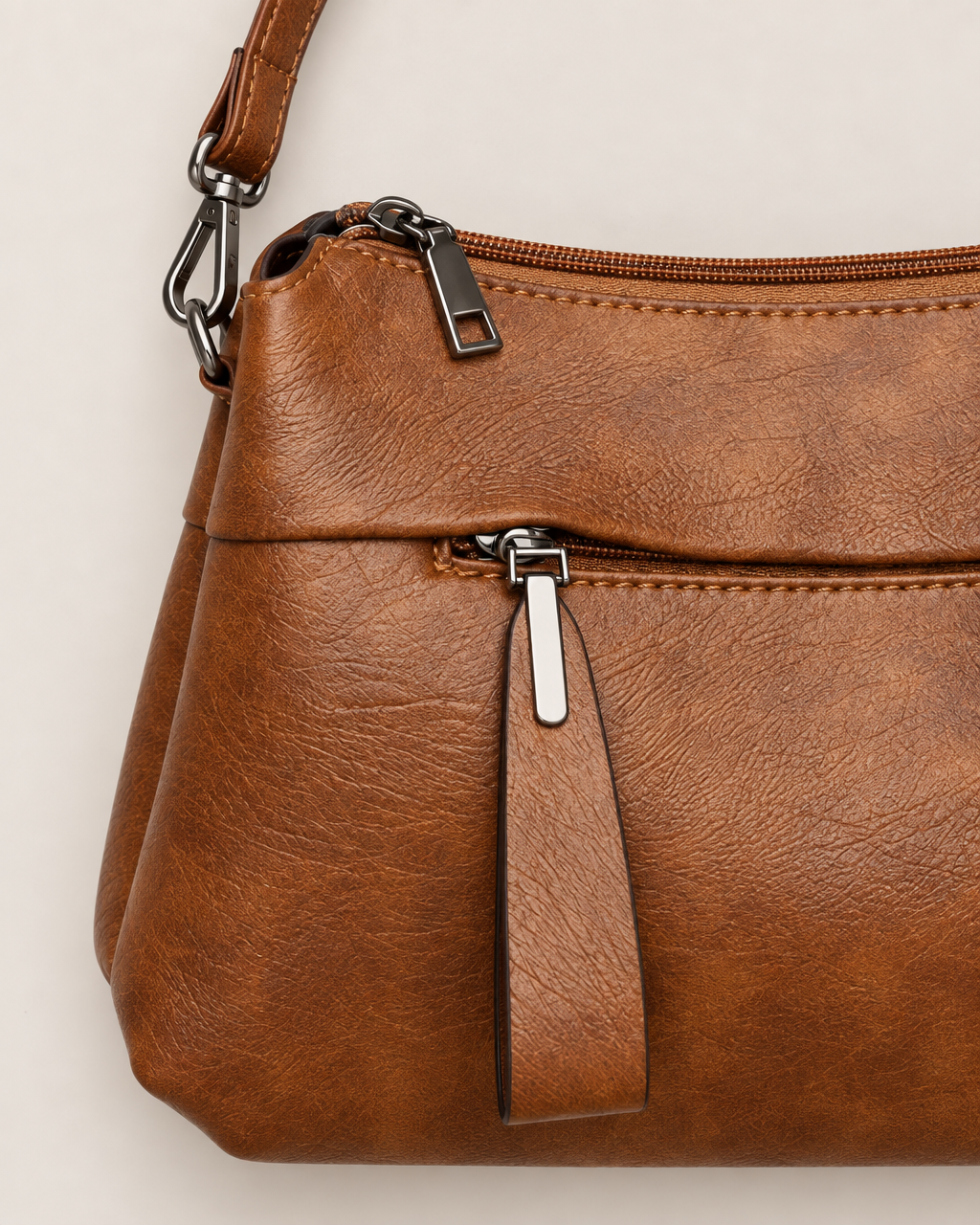Genevieve Organized Everyday Crossbody Bag - detail of the material and strap attachment, Brown