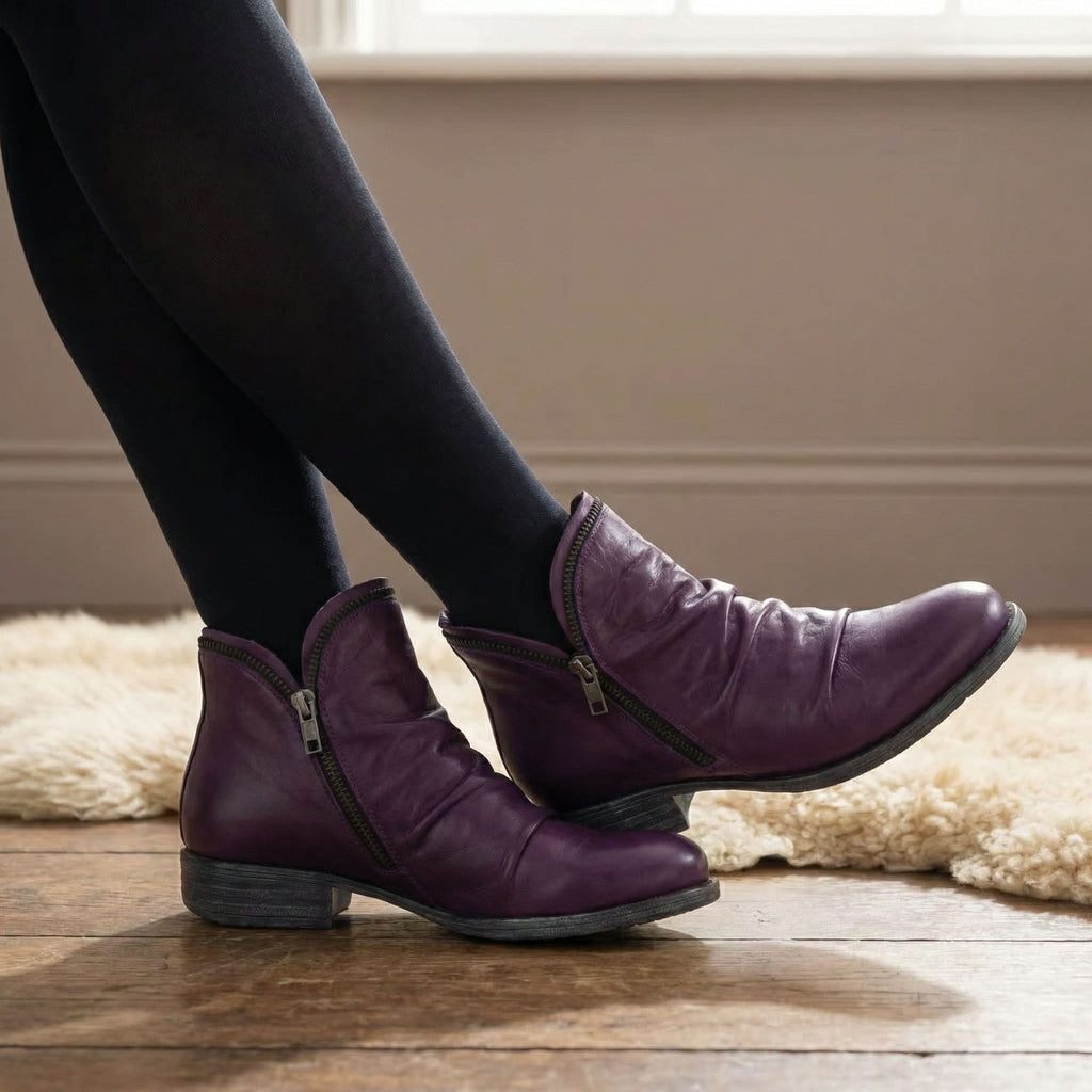 Angled view of a single red boot on a clean surface, highlighting its lightweight construction and airy feel.