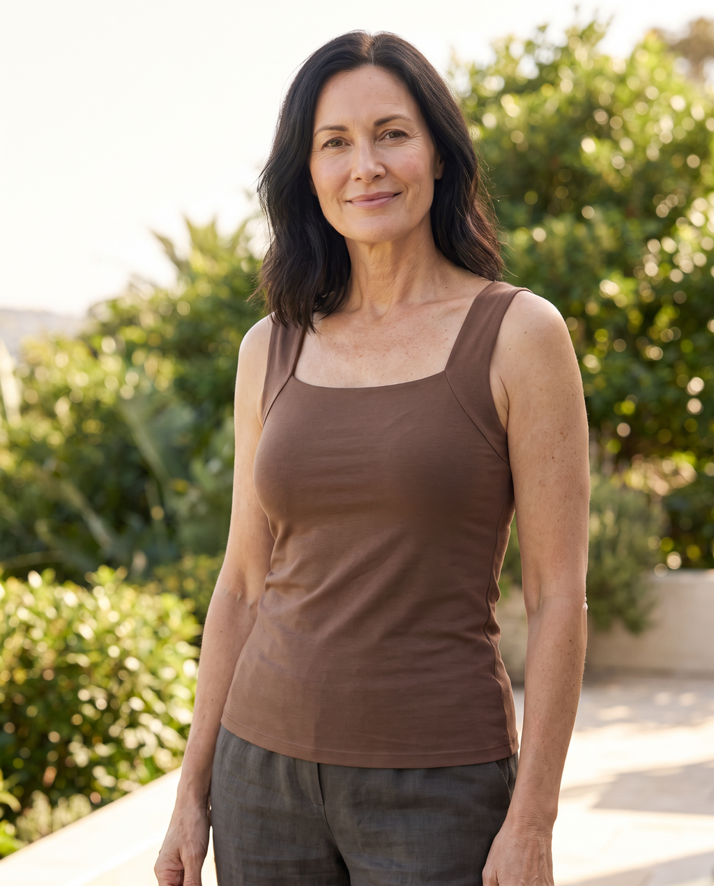 Kira Built-in Bra Tank Top worn by a woman, Adeline Wear